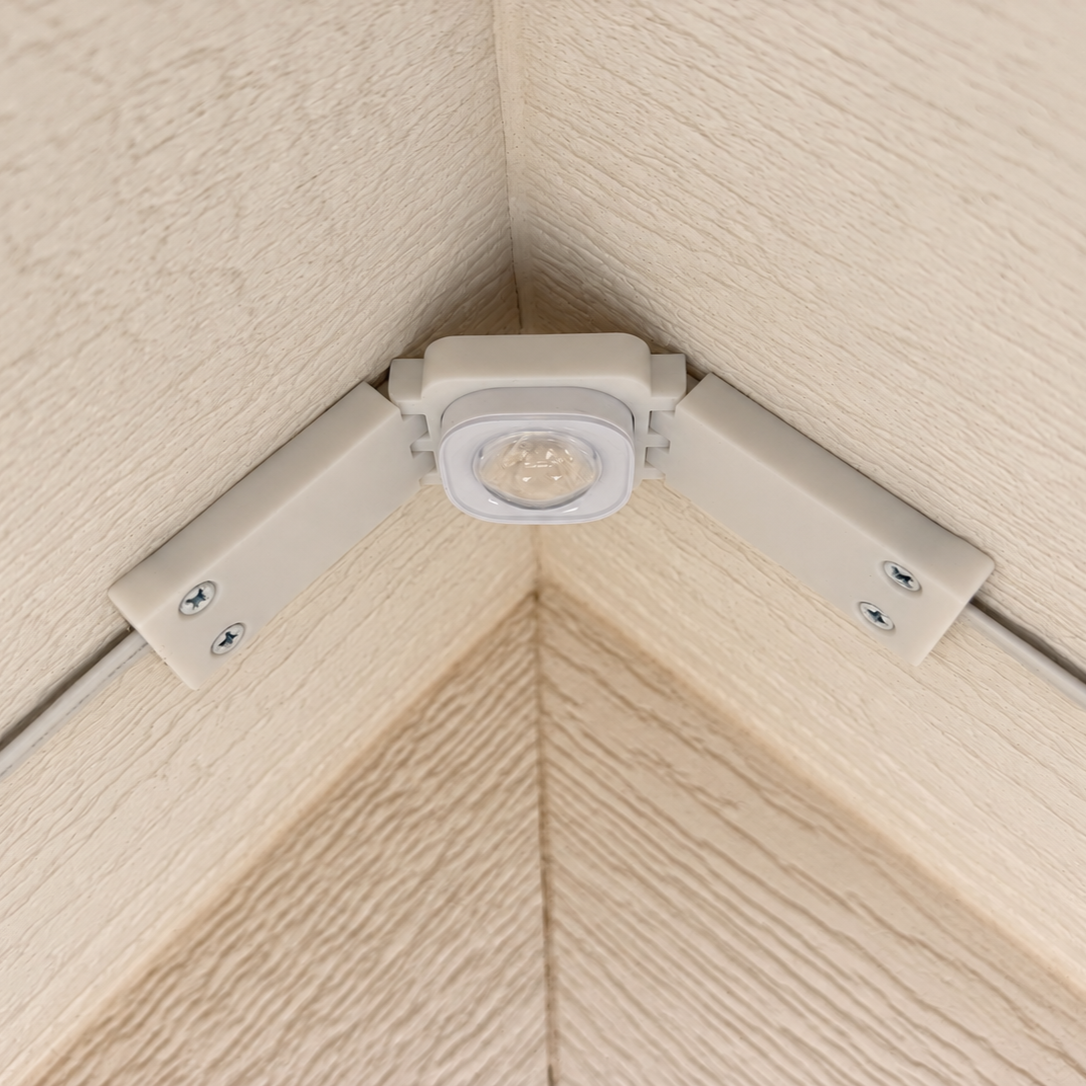 White Pro Slim Peak Hinge installed on a cream soffit peak with Govee Pro light mounted.