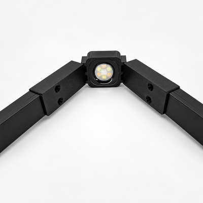 Black Govee Pro Channel Fit Peak Hinge holding a permanent outdoor LED light with black channels extending along both sides.