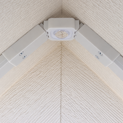 Close-up of a white Govee Pro Channel Fit Peak Hinge with an installed LED light beneath a gable roof peak.
